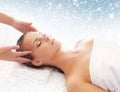 Young attractive woman getting massaging treatment on the snow Royalty Free Stock Photo