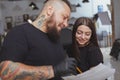 Young attractive woman getting new tattoo by professional tattooist