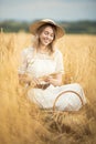 Young attractive woman and golden wheat field. Royalty Free Stock Photo