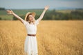 Young attractive woman and golden wheat field. Royalty Free Stock Photo