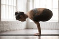 Young attractive woman in Handstand Urdhva Kukkutasana pose, whi