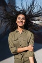 Young attractive woman with her wavy hair in the wind smiling Royalty Free Stock Photo