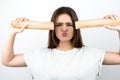 Young attractive woman holding baguette devided into two parts near her head holding her lips in kiss standing on isolated white Royalty Free Stock Photo