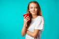 Young attractive woman holding a cup of hot drink Royalty Free Stock Photo