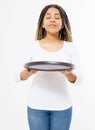 Young attractive woman holding empty pizza tray and sniff good smell food isolated on white background. Copy space and mock up. Royalty Free Stock Photo