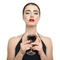 Young attractive woman holding glass of red wine. Lady drinks alcoholic drink Royalty Free Stock Photo