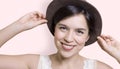 Young attractive woman holding her hat and smiling Royalty Free Stock Photo