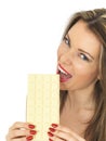 Young Attractive Woman Holding a Large White Chocolate Bar Royalty Free Stock Photo