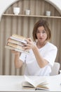 Young attractive woman holding many books for studying Royalty Free Stock Photo