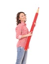 Young attractive woman with huge red pencil Royalty Free Stock Photo