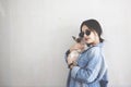 Young attractive woman hugging pussy cat in hands. Cute and glamorous girl in trendy sunglasses posing with her Siamese cat Royalty Free Stock Photo
