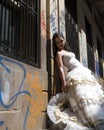 Young attractive woman leaning against graffiti wall