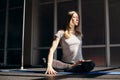 A young attractive woman with light hair practices yoga. Yoga, fitness, healthy lifestyle Royalty Free Stock Photo