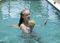 The young attractive woman with long hair in a swimwear in the pool with cocktail in coconut Royalty Free Stock Photo