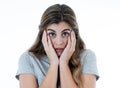 Young attractive woman looking scared, frightened and shocked. Human expressions and emotions Royalty Free Stock Photo