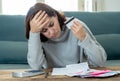 Upset young woman stressed about credit card debts and payments not happy accounting finances Royalty Free Stock Photo