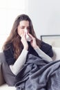 Woman sneezing nose with tissue Royalty Free Stock Photo