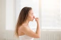 Young attractive woman making Alternate Nostril Breathing, white Royalty Free Stock Photo