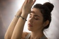 Young attractive woman making namaste with closed eyes, studio, Royalty Free Stock Photo
