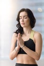 Young attractive woman making namaste gesture near the sunny win Royalty Free Stock Photo