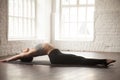 Young attractive woman in Matsyasana pose, white loft studio bac Royalty Free Stock Photo