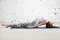 Young attractive woman in Matsyasana pose, white studio backgrou Royalty Free Stock Photo