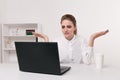Young attractive woman at modern office desk, working on laptop, massaging temples to forget about constant headaches Royalty Free Stock Photo