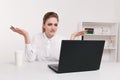 Young attractive woman at modern office desk, working on laptop, massaging temples to forget about constant headaches Royalty Free Stock Photo