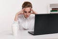 Young attractive woman at modern office desk, working on laptop, massaging temples to forget about constant headaches Royalty Free Stock Photo