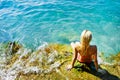 Young attractive woman near the water Royalty Free Stock Photo