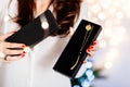 Young attractive woman opening black present box with necklace.