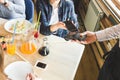 Young attractive woman paying in cafe with contactless smartphone payment Royalty Free Stock Photo