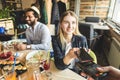 Young attractive woman paying in cafe with contactless smartphone payment Royalty Free Stock Photo