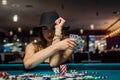 young attractive woman playing poker at table with stacks of chips and cards Royalty Free Stock Photo