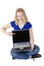 Young attractive woman pointing at laptop display