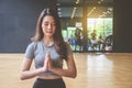 Young attractive woman practicing yoga with closed eyes relaxing, sitting in Padmasana exercise, practicing yoga, Royalty Free Stock Photo