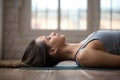 Young attractive woman practicing yoga, doing Dead Body, close u Royalty Free Stock Photo