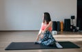 Young attractive woman practicing yoga, doing Half lord of the fishes exercise, Ardha Matsyendrasana pose with namaste Royalty Free Stock Photo