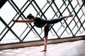 Young attractive woman practicing yoga doing Warrior 3 Pose large triangular window background