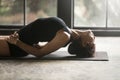 Young attractive woman in Matsyasana pose, studio background Royalty Free Stock Photo