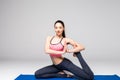 Young attractive woman practicing yoga, standing in different yoga exercise, wearing sportswear isolated on grey background. Serie Royalty Free Stock Photo