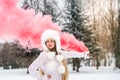 Young and attractive woman with red smoke bomb in park Royalty Free Stock Photo