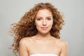 Young attractive woman redhead model with natural makeup and long healthy brown curly hair on white background portrait. Royalty Free Stock Photo