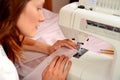 Young attractive woman sewing on machine Royalty Free Stock Photo
