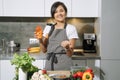 Young attractive woman showing nutritional supplements or vitamins in the kitchen. Balanced nutrition, health and diet concept Royalty Free Stock Photo