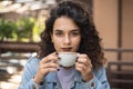 A young attractive woman sitting in a cafe with a coffe