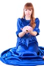 Young attractive woman sitting in a long blue evening dress Royalty Free Stock Photo