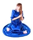 Young attractive woman sitting in a long blue evening dress Royalty Free Stock Photo