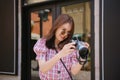 Young attractive woman checking photos on retro equipment.