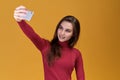 Young attractive woman taking photo on memory on isolated background. A beautiful cute girl Royalty Free Stock Photo